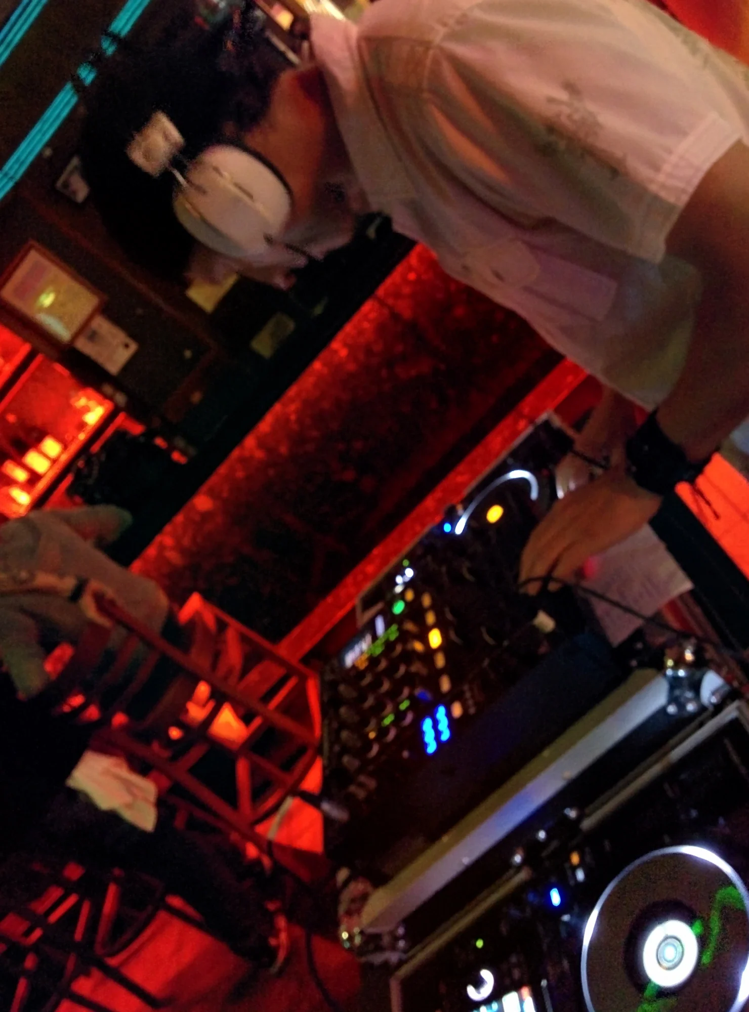 DJ Eddie Black mixing live in a red-lit Calgary club — nightclub and open format DJ