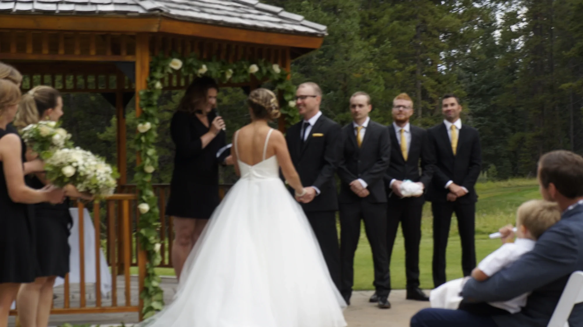 Outdoor wedding ceremony at wooden gazebo — Calgary wedding DJ and MC services